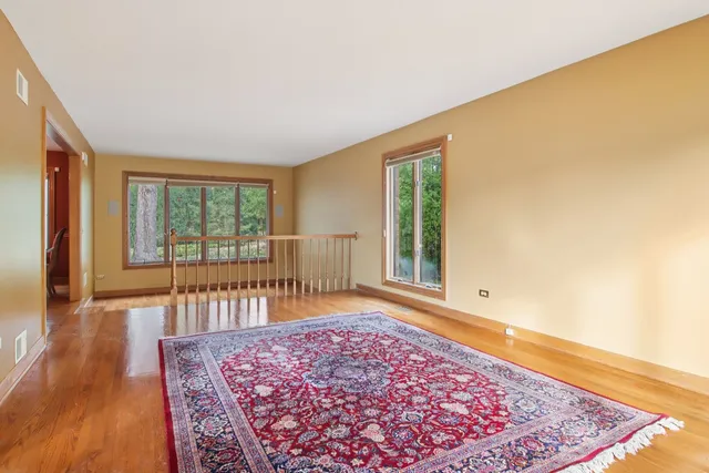 a view of a room with wooden floor and windows