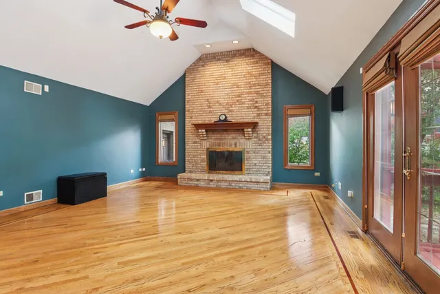 a view of an empty room with a fireplace and a window
