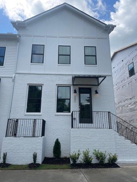 2491 Sycamore Road Northwest Atlanta, GA 30318 - Photo 1 of 1 a view of a house with more windows and a yard