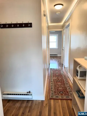 a view of a room with wooden floor and window