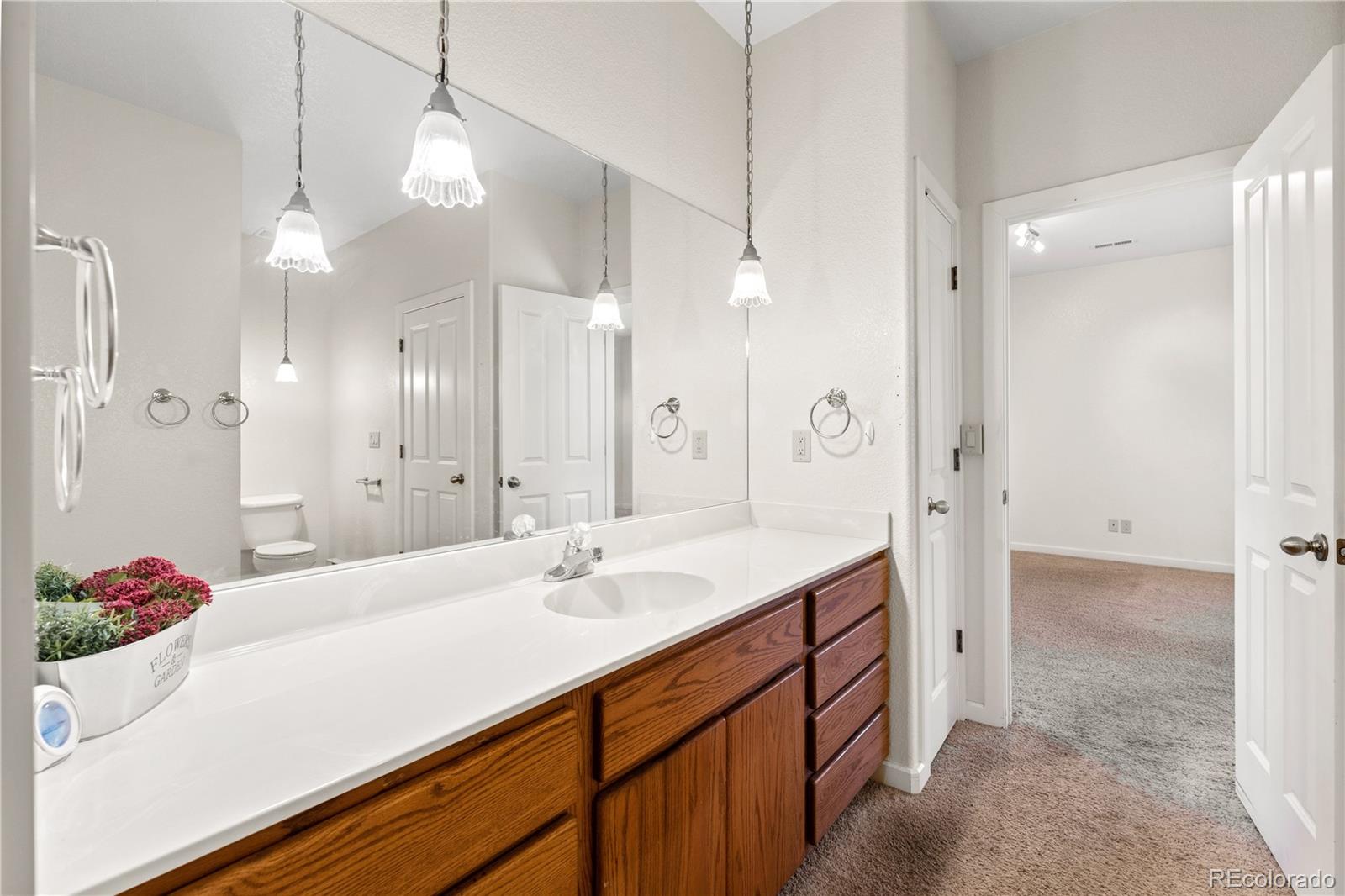 835 Oak Ridge Road Manitou Springs, CO 80829 - Photo 12 of 35 a spacious bathroom with a sink double vanity granite and a shower