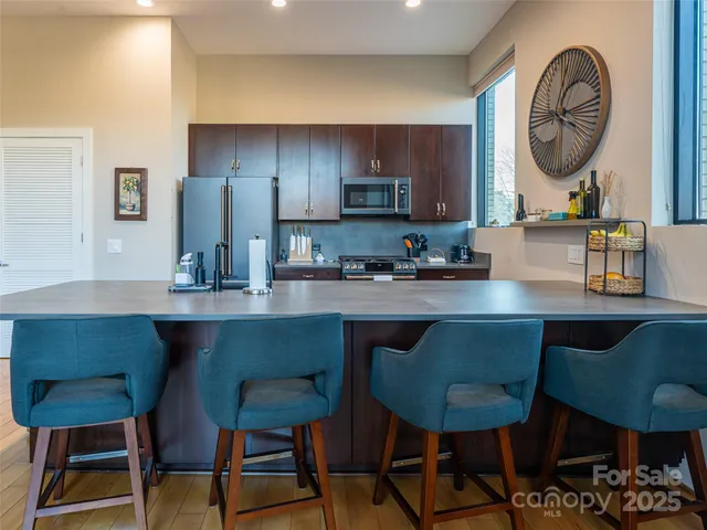 a kitchen with a table chairs and a stove