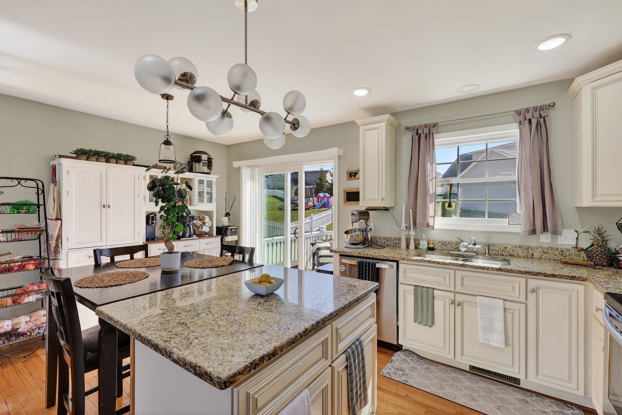 235 Locustdale Loop Shenandoah, VA 22849 - Photo 12 of 30 a kitchen with a stove a sink a dining table and chairs