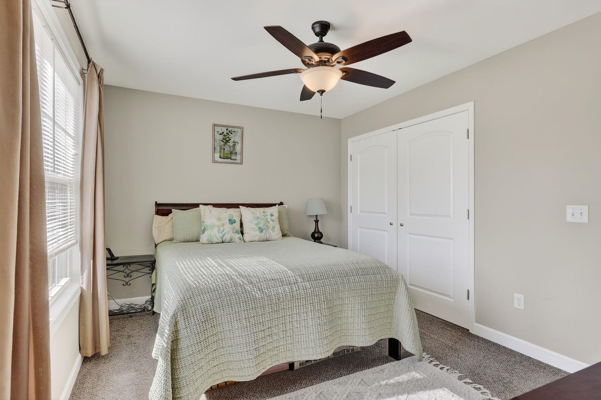 235 Locustdale Loop Shenandoah, VA 22849 - Photo 14 of 30 a bedroom with a bed and a large mirror with a wooden floor