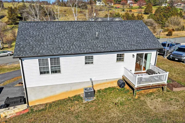 an aerial view of a house with a yard