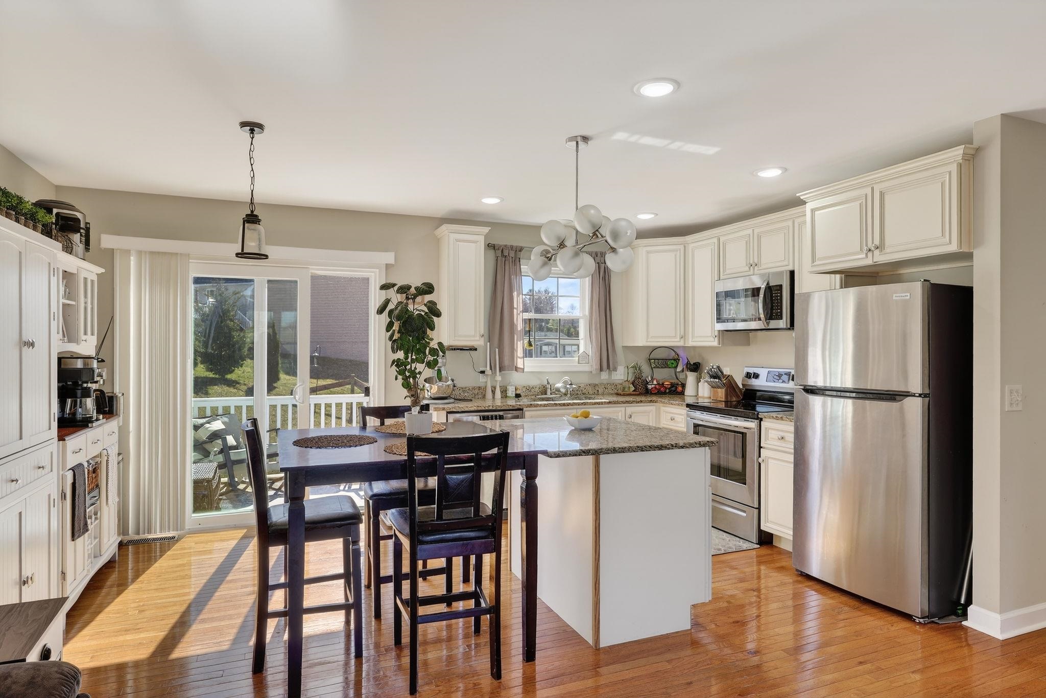 235 Locustdale Loop Shenandoah, VA 22849 - Photo 4 of 30 a kitchen with a table chairs refrigerator and microwave