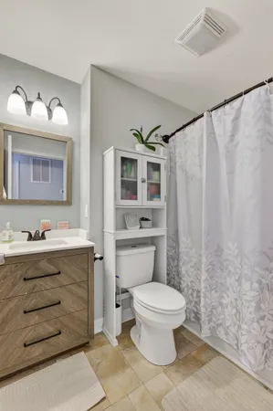 a bathroom with a toilet a sink and a mirror