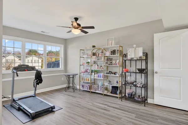 a living room with lots of furniture and a book shelf
