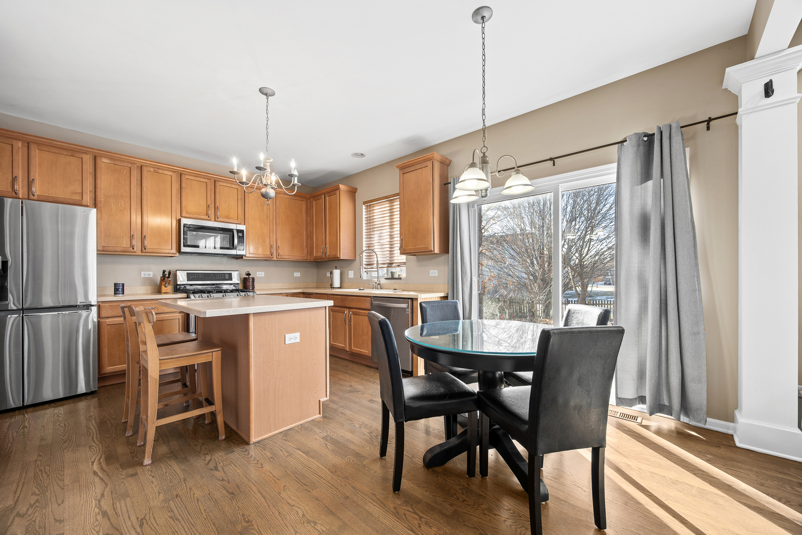 133 North Cranberry Street Bolingbrook, IL 60490 - Photo 11 of 46 a kitchen with stainless steel appliances granite countertop a refrigerator a stove a sink a dining table and chairs