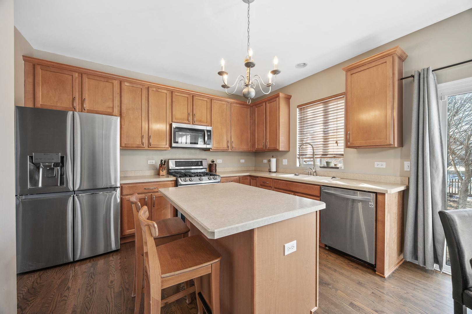 133 North Cranberry Street Bolingbrook, IL 60490 - Photo 12 of 46 a kitchen with kitchen island a counter top space a sink stainless steel appliances and cabinets