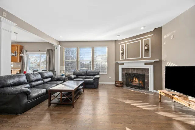 a living room with furniture a fireplace and a flat screen tv