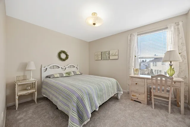 a bedroom with a bed dresser and a window