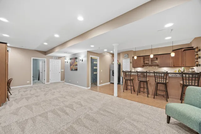 a living room with stainless steel appliances kitchen island furniture and a kitchen view