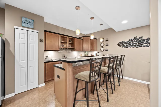 a kitchen with stainless steel appliances granite countertop a sink and cabinets