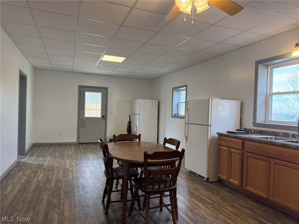 23033 Cadiz Road Freeport, OH 43973 - Photo 7 of 31 Dining space with dark wood-style flooring, a paneled ceiling, and ceiling fan