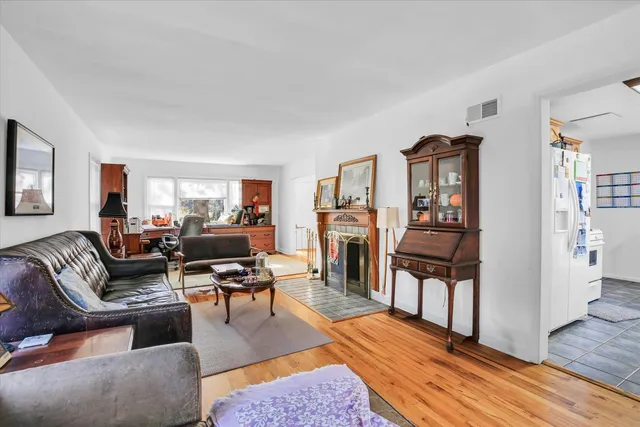 a living room with furniture fireplace and wooden floor