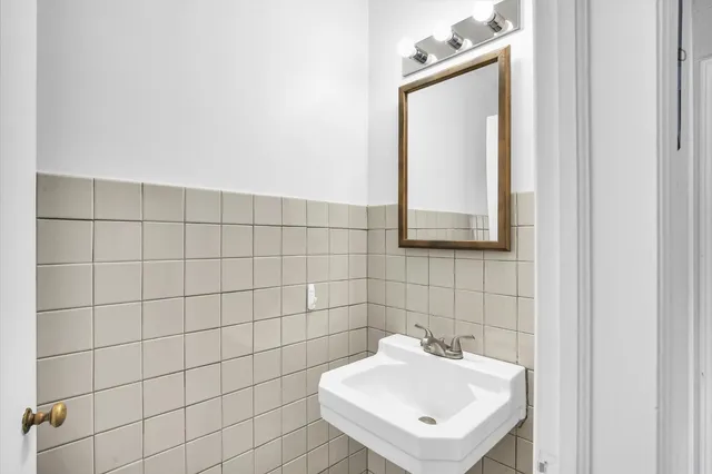 a bathroom with a sink a mirror and vanity