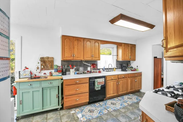 a kitchen with a sink stove and window