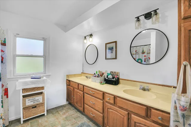 a bathroom with a double vanity sink and a mirror