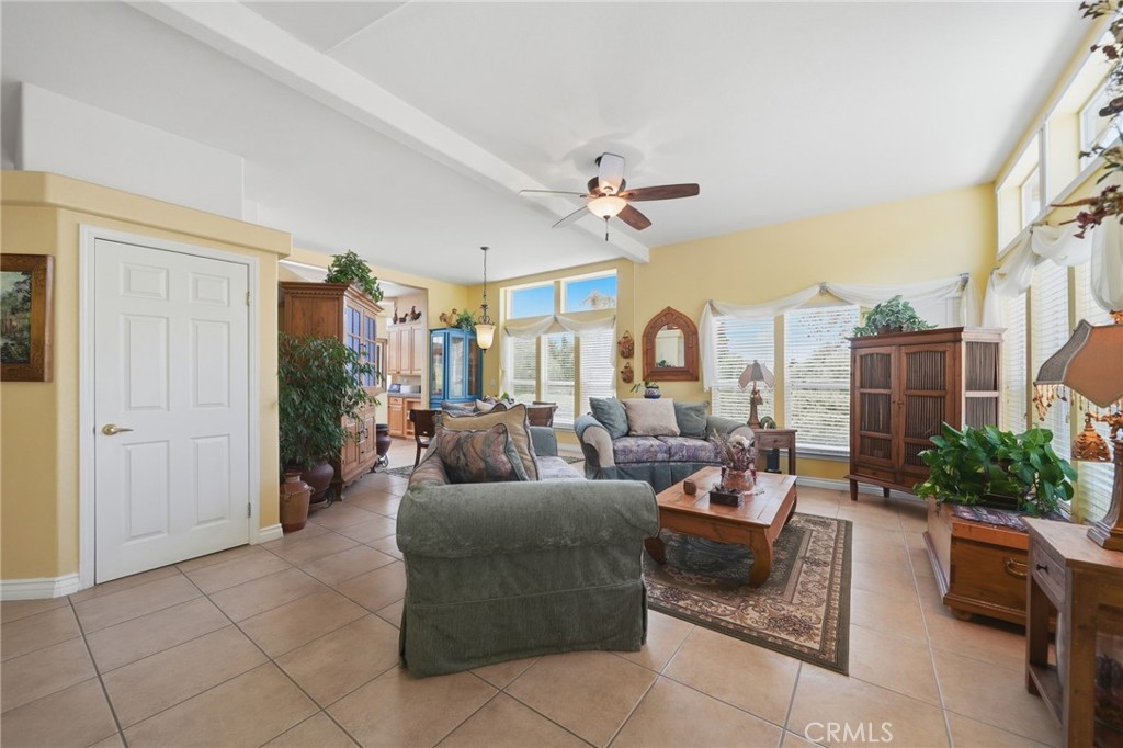 35780 Greer Road Murrieta, CA 92562 - Photo 3 of 56 Living room w tile flooring, custom paint and ceiling fan/light fixture.
