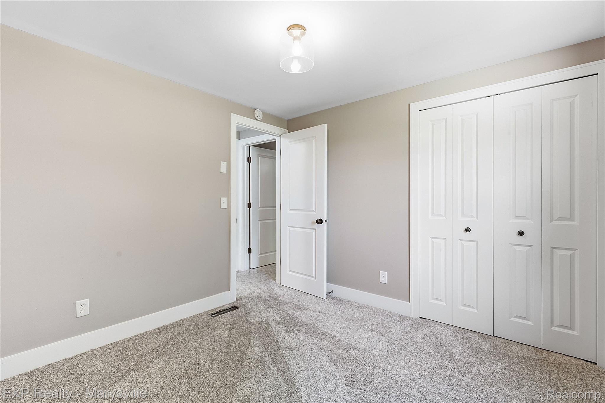 13739 Yale Road Yale, MI 48097 - Photo 25 of 50 Neutral wall color, light gray carpeting, white trim, white interior doors, and a ceiling-mounted light fixture