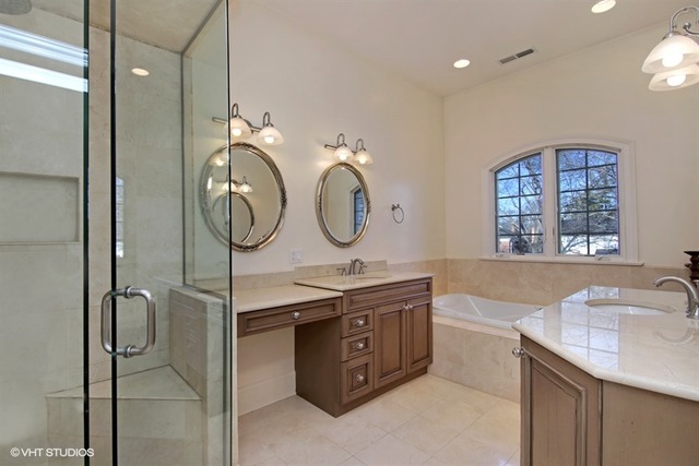 1055 Cherokee Road Wilmette, IL 60091 - Photo 15 of 25 a bathroom with a granite countertop sink a mirror and a shower