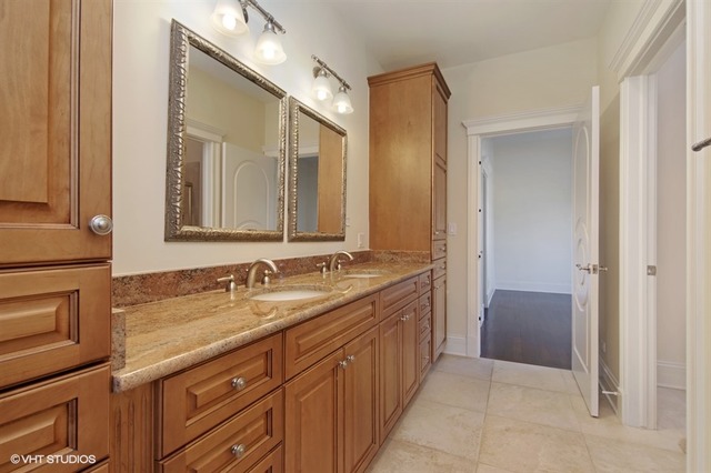 1055 Cherokee Road Wilmette, IL 60091 - Photo 17 of 25 a bathroom with a sink and a mirror