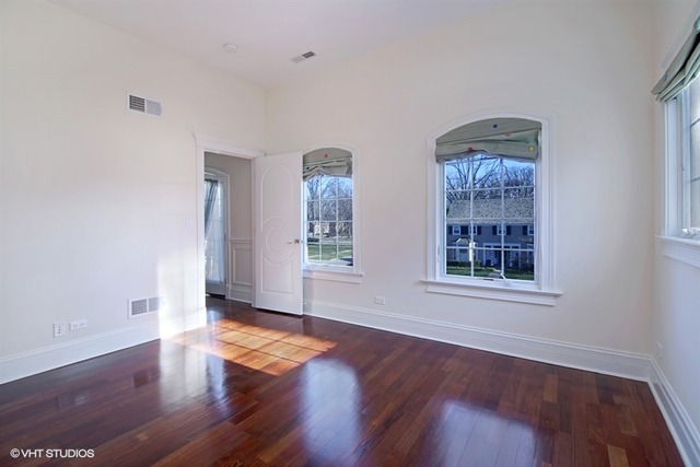 1055 Cherokee Road Wilmette, IL 60091 - Photo 18 of 25 an empty room with wooden floor and windows