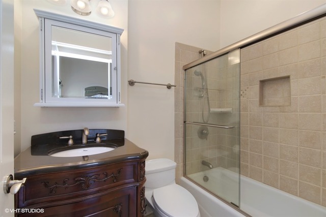 1055 Cherokee Road Wilmette, IL 60091 - Photo 19 of 25 a bathroom with a sink a toilet and shower