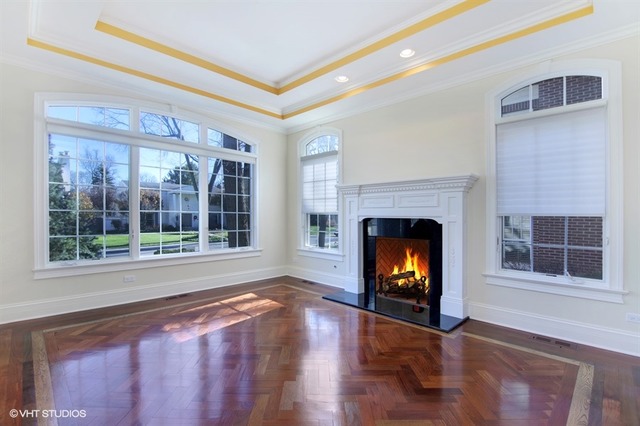 1055 Cherokee Road Wilmette, IL 60091 - Photo 3 of 25 a view of an empty room with wooden floor and a window