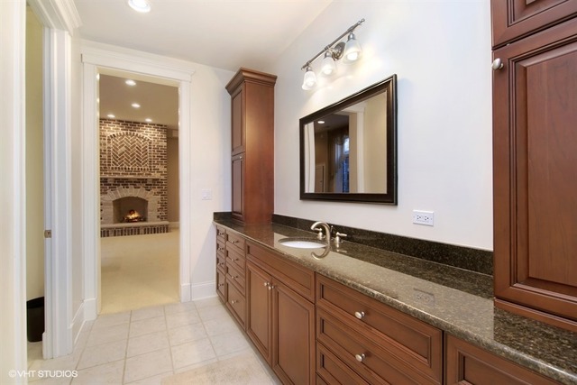 1055 Cherokee Road Wilmette, IL 60091 - Photo 22 of 25 a bathroom with a double vanity sink and mirror