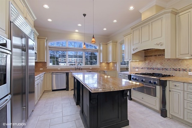 1055 Cherokee Road Wilmette, IL 60091 - Photo 7 of 25 a kitchen with stainless steel appliances granite countertop a stove a sink dishwasher and a refrigerator
