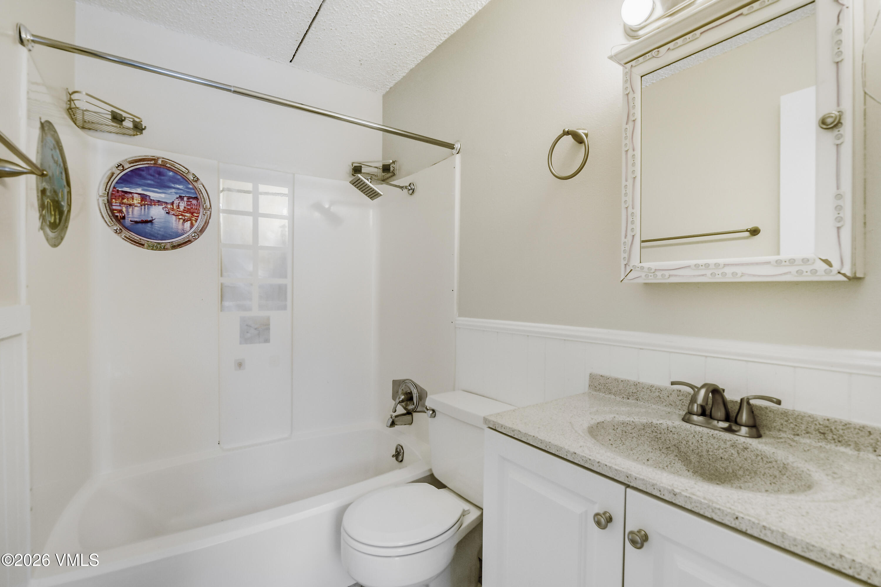 4506 Spruce Way, Unit 20 Vail, CO 81657 - Photo 12 of 17 a bathroom with a granite countertop sink a toilet and a bathtub