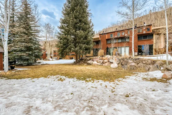 a view of a patio with table and chairs and potted plants