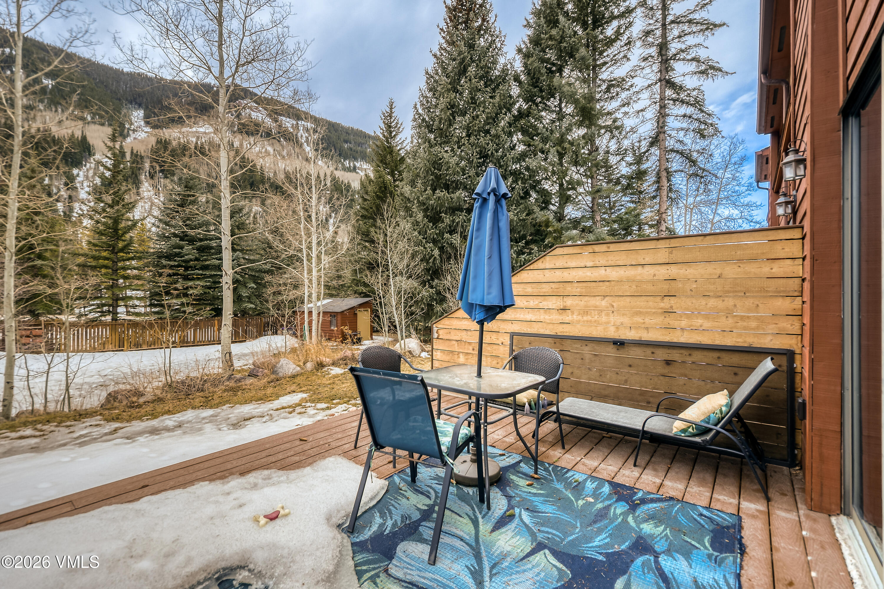4506 Spruce Way, Unit 20 Vail, CO 81657 - Photo 15 of 17 a view of a patio with table and chairs and potted plants