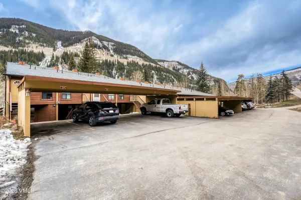a view of a garage with parked cars