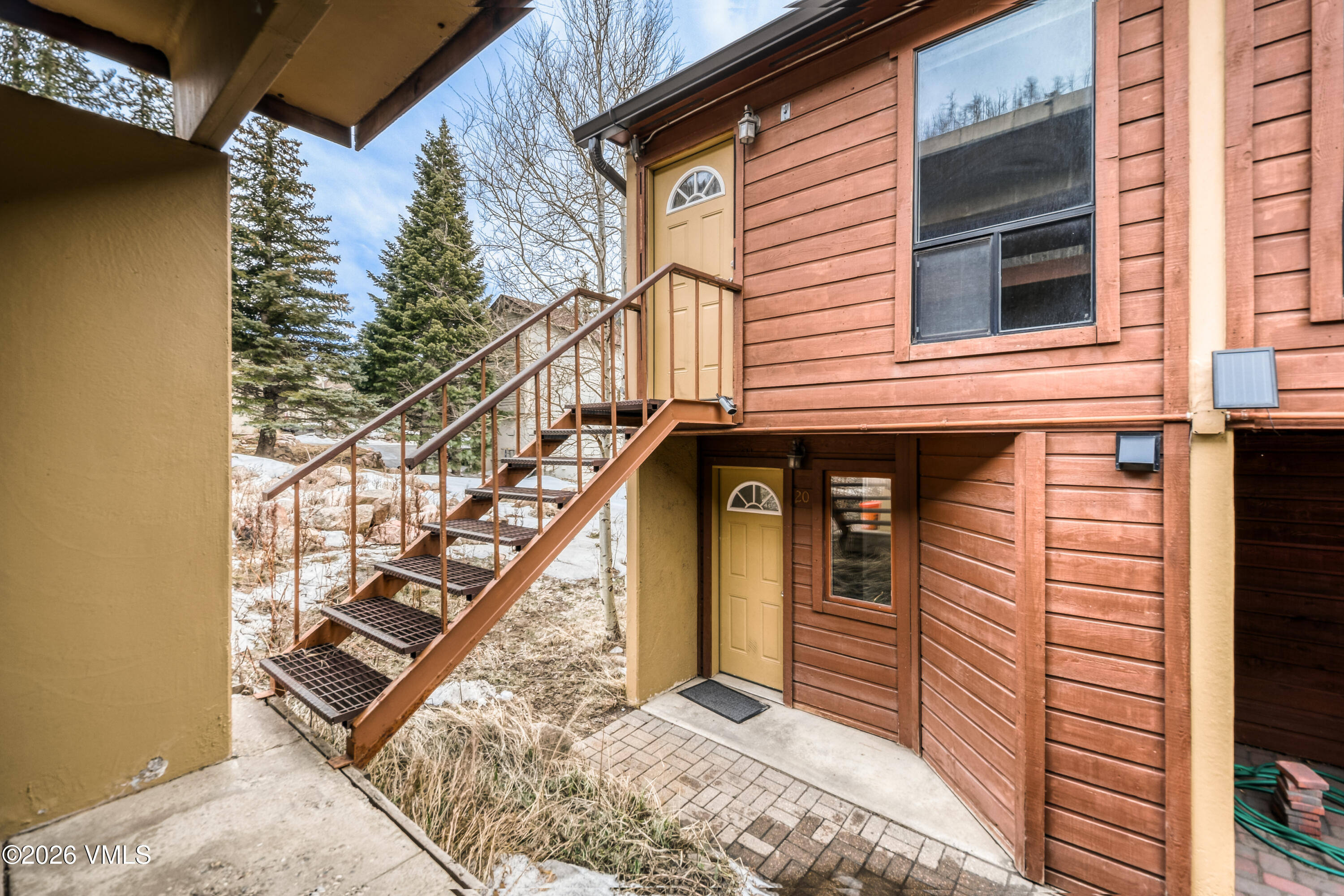 4506 Spruce Way, Unit 20 Vail, CO 81657 - Photo 2 of 17 a view of a house with wooden fence and two windows