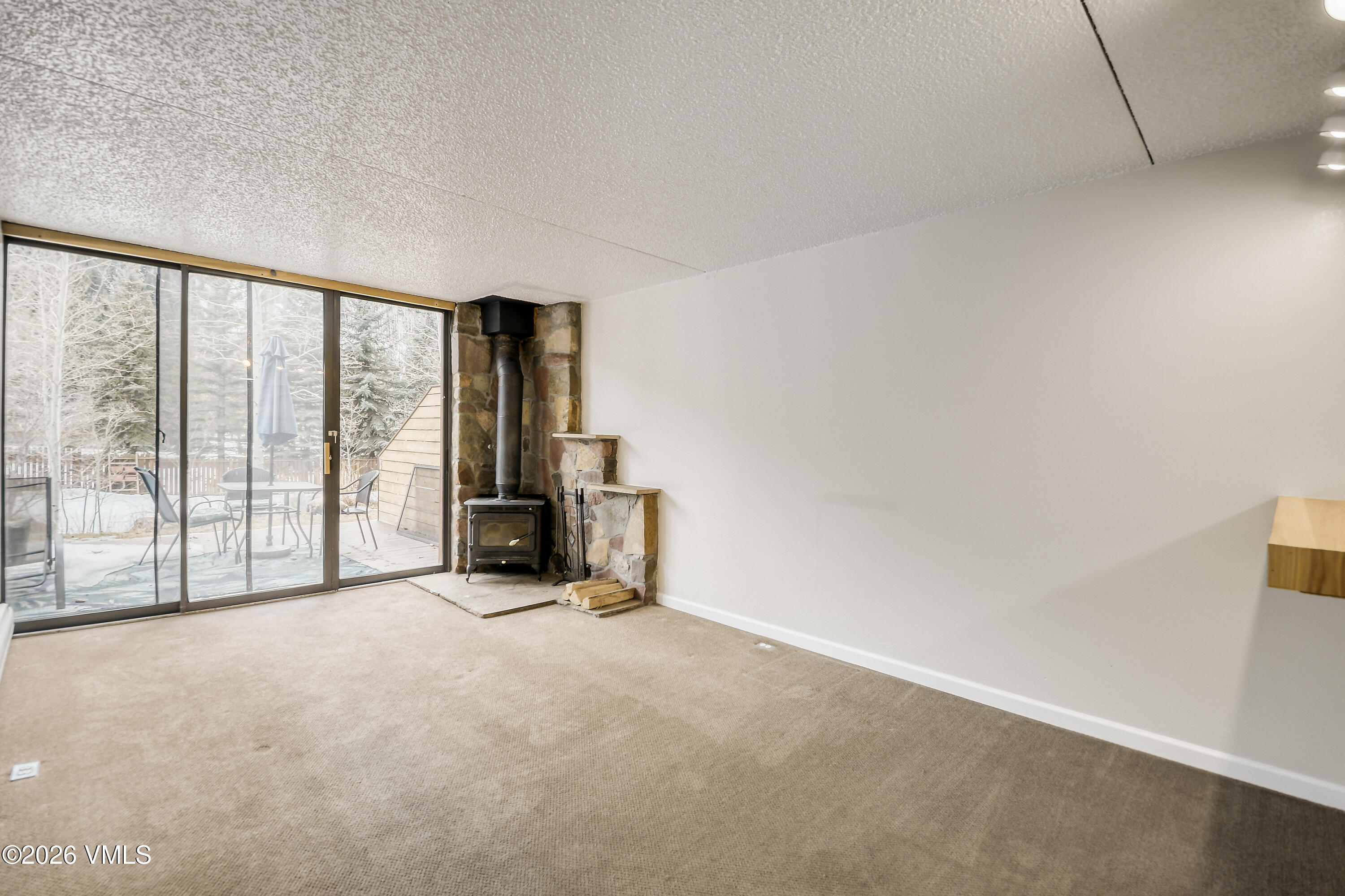 4506 Spruce Way, Unit 20 Vail, CO 81657 - Photo 3 of 17 a view of an empty room with glass door