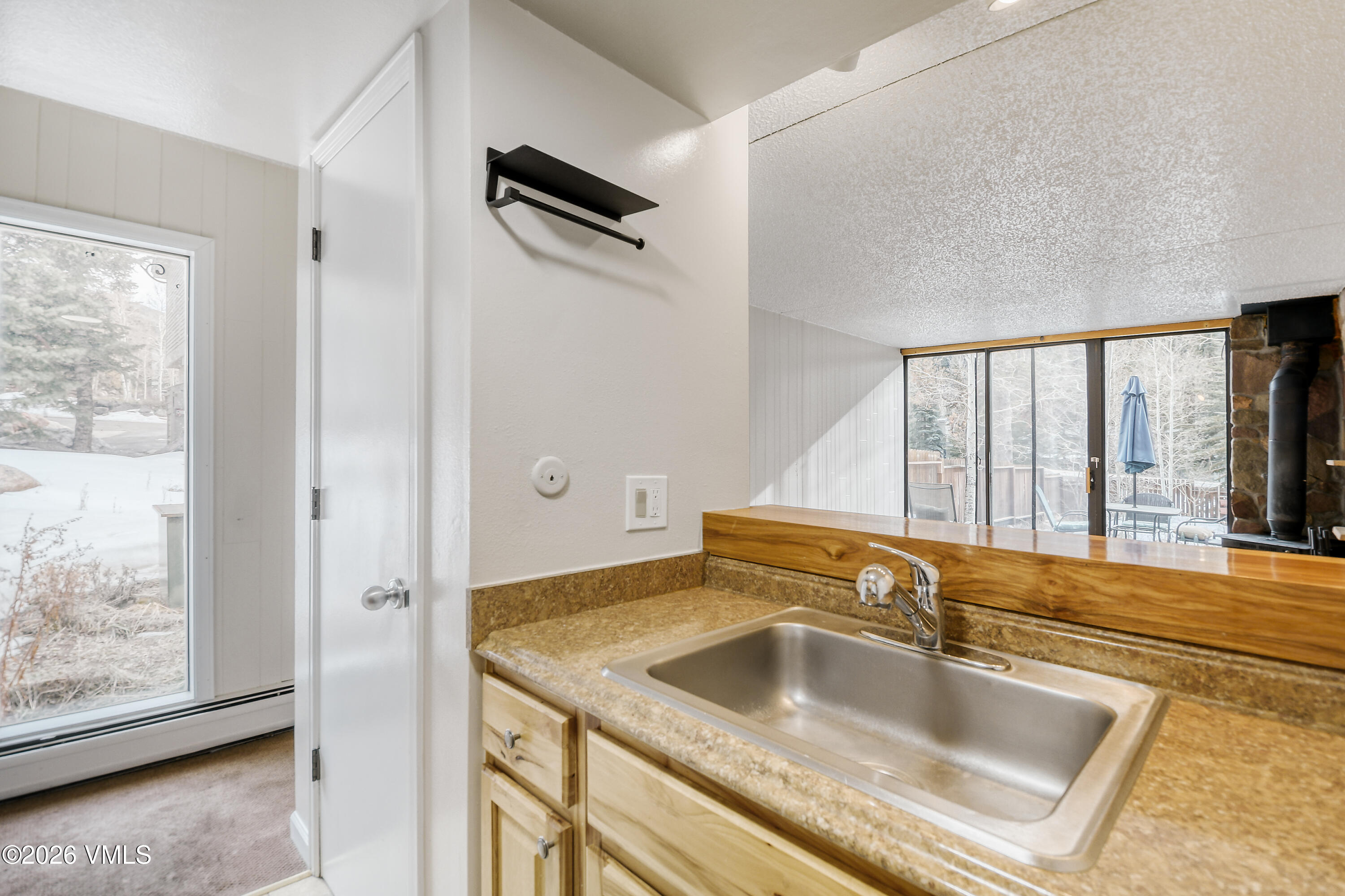 4506 Spruce Way, Unit 20 Vail, CO 81657 - Photo 6 of 17 a kitchen with a sink and a refrigerator with wooden floor