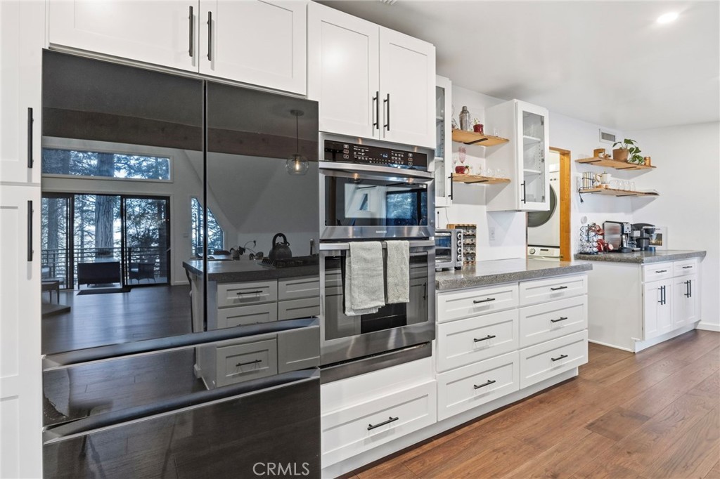 1349 Valley View Way Crestline, CA 92325 - Photo 13 of 43 a kitchen with stainless steel appliances kitchen island granite countertop a refrigerator and cabinets