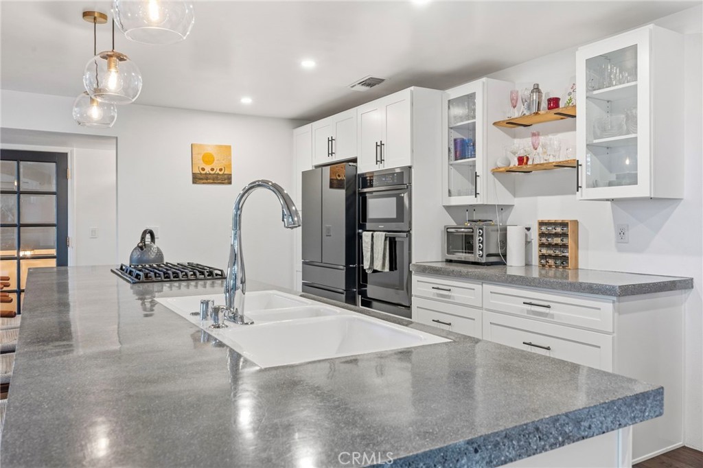 1349 Valley View Way Crestline, CA 92325 - Photo 15 of 43 a kitchen with stainless steel appliances granite countertop a sink and a refrigerator