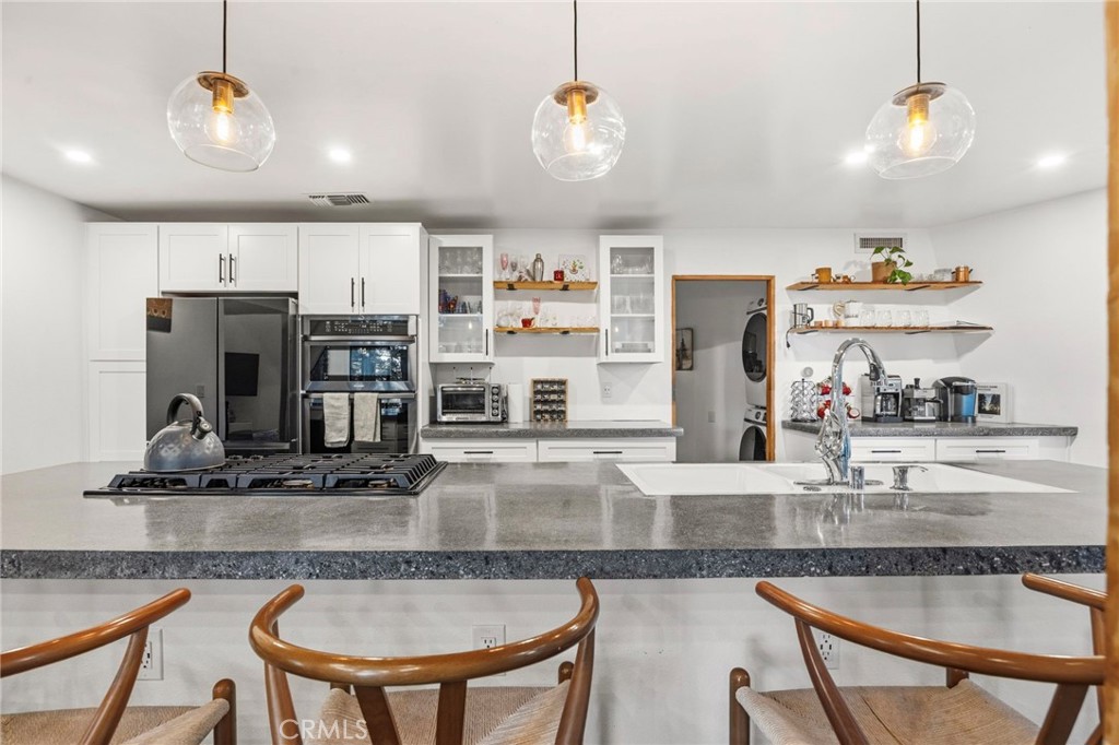 1349 Valley View Way Crestline, CA 92325 - Photo 16 of 43 a kitchen with kitchen island granite countertop a table and chairs in it