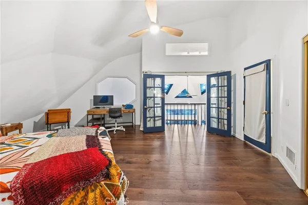 a bedroom with furniture and a wooden floor