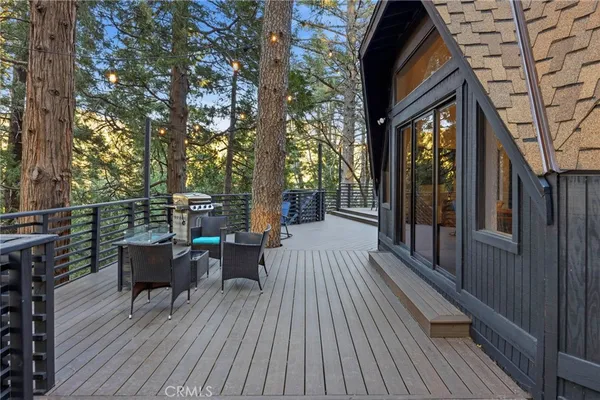 a view of a balcony with chairs and wooden floor