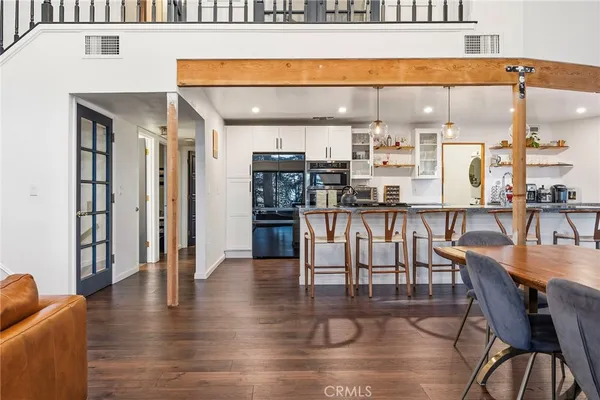 a dining room with furniture and wooden floor