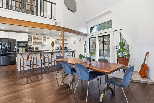 a dining room with furniture and wooden floor