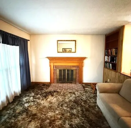 a view of livingroom with window and fireplace