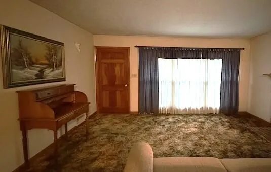 a living room with a couch and a window