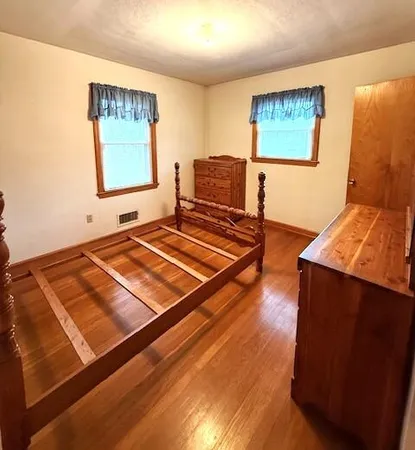 a room with wooden floor and painting on the wall