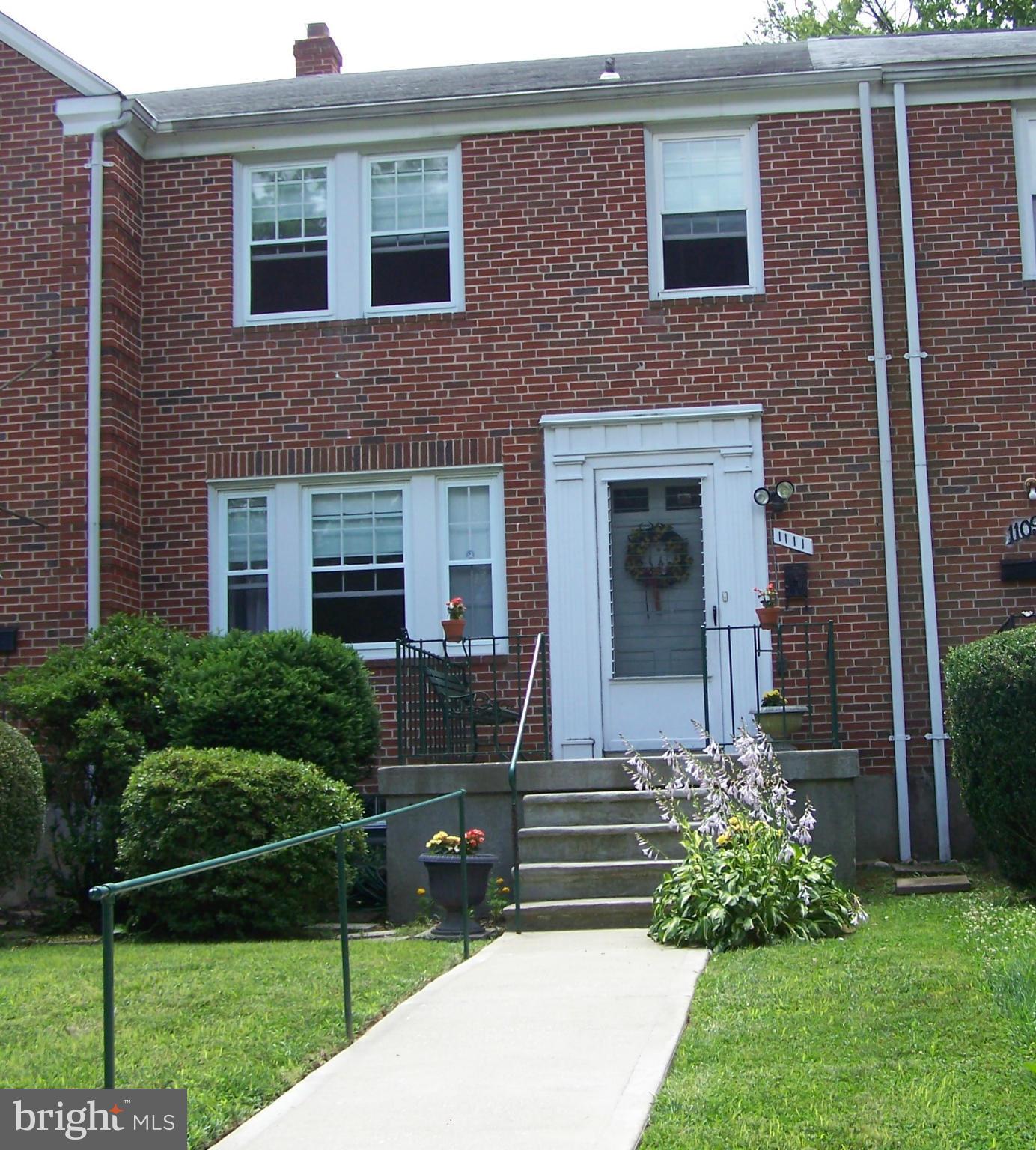 1111 Granville Road Baltimore, MD 21207 - Photo 2 of 19 a front view of a house with a yard